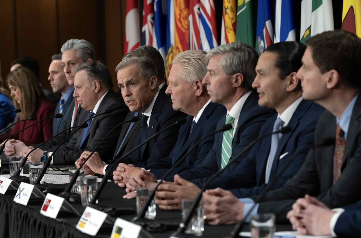 Premiers look on as Prime Minister Mark Carney delivers opening remarks at a news conference following the First Ministers Meeting in Ottawa on Jan. 29, 2026. (The Canadian Press/Adrian Wyld)