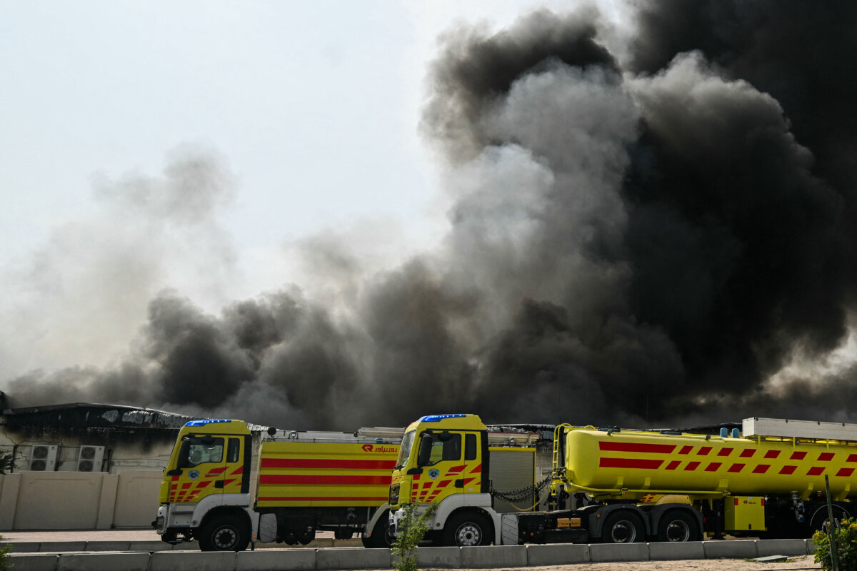 A plume of smoke rises from a reported Iranian strike in the industrial district of Doha on March 1, 2026. (Photo by Mahmud HAMS / AFP via Getty Images)