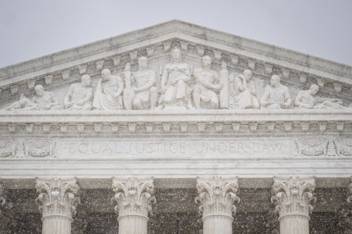 Snow falls outside of the Supreme Court in Washington on March 2, 2026. (Madalina Kilroy/The Epoch Times)