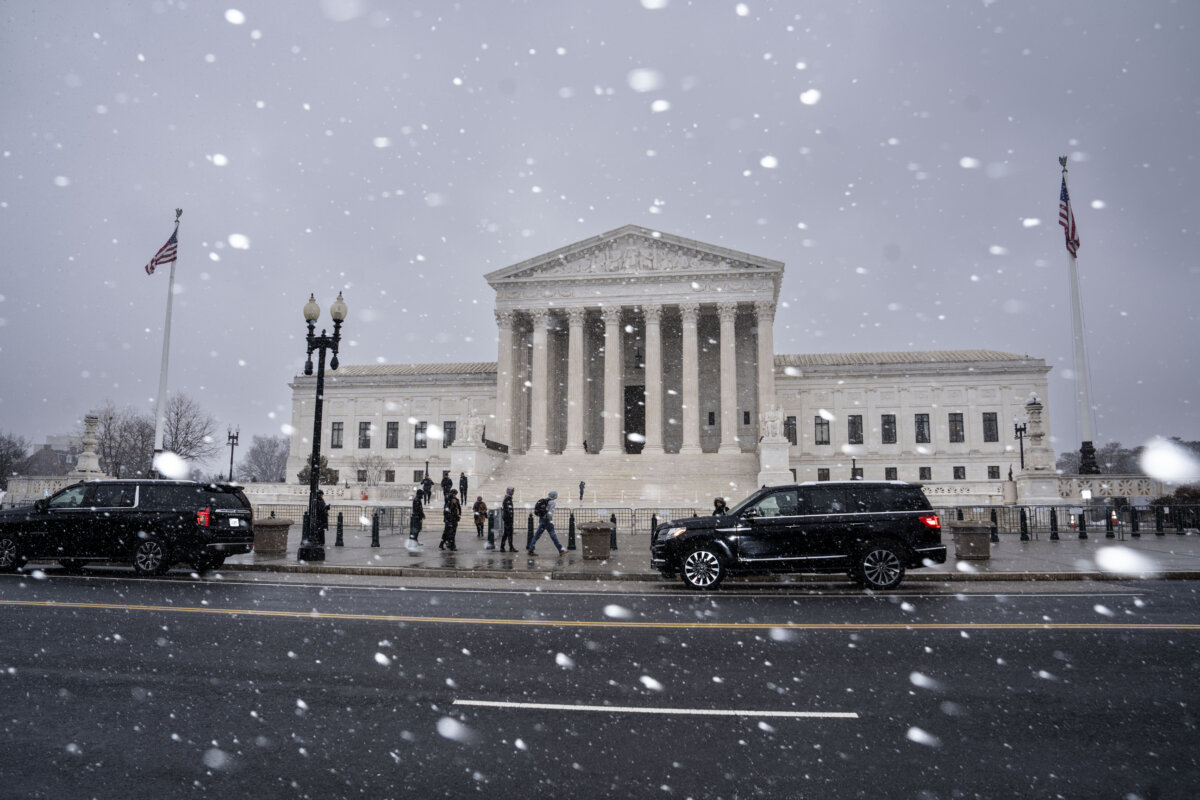 Snow falls outside of the Supreme Court in Washington on March 2, 2026. (Madalina Kilroy/The Epoch Times)