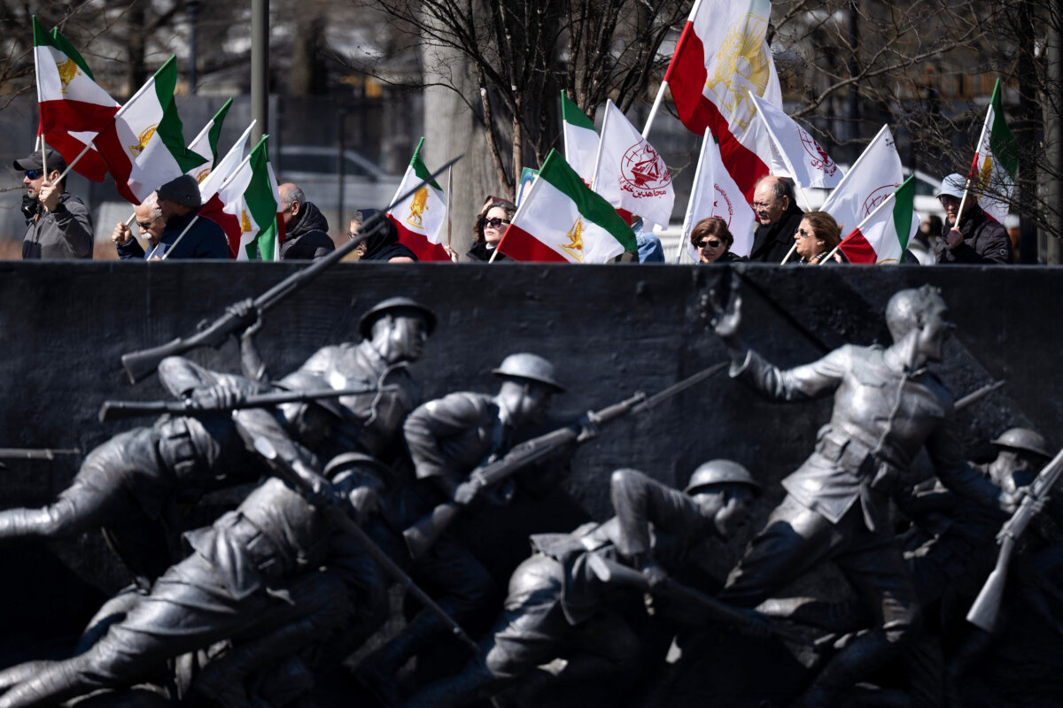 Supporters of regime change in Iran pass the American Expeditionary Forces Memorial as they rally near the White House in Washington, on March 1, 2026. (Brendan Smialowski/AFP via Getty Images)