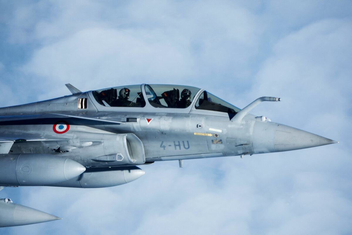 A French Air Force Dassault Rafale B aircraft escorts an Airbus A330 transporting French President Emmanuel Macron during a flight display moments before arriving at the Nuclear Submarine Navy Base of Ile Longue in Crozon, France, on March 2, 2026. (Yoan Valat/Pool/AFP via Getty Images)