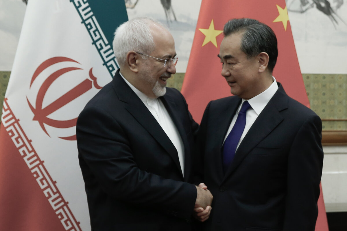 Chinese State Councilor and Foreign Minister Wang Yi (R) meets Iranian Foreign Minister Mohammad Javad Zarif at the Diaoyutai State Guesthouse in Beijing on May 13, 2018. (Thomas Peter/AFP via Getty Images)