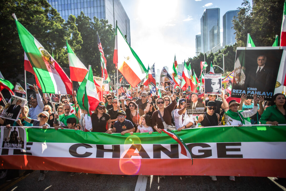Members of the Iranian community and supporters hold signs and pre-regime Iranian flags during a "Solidarity with the People of Iran" event in Los Angeles on Jan. 18, 2026. (Apu Gomes/Getty Images)