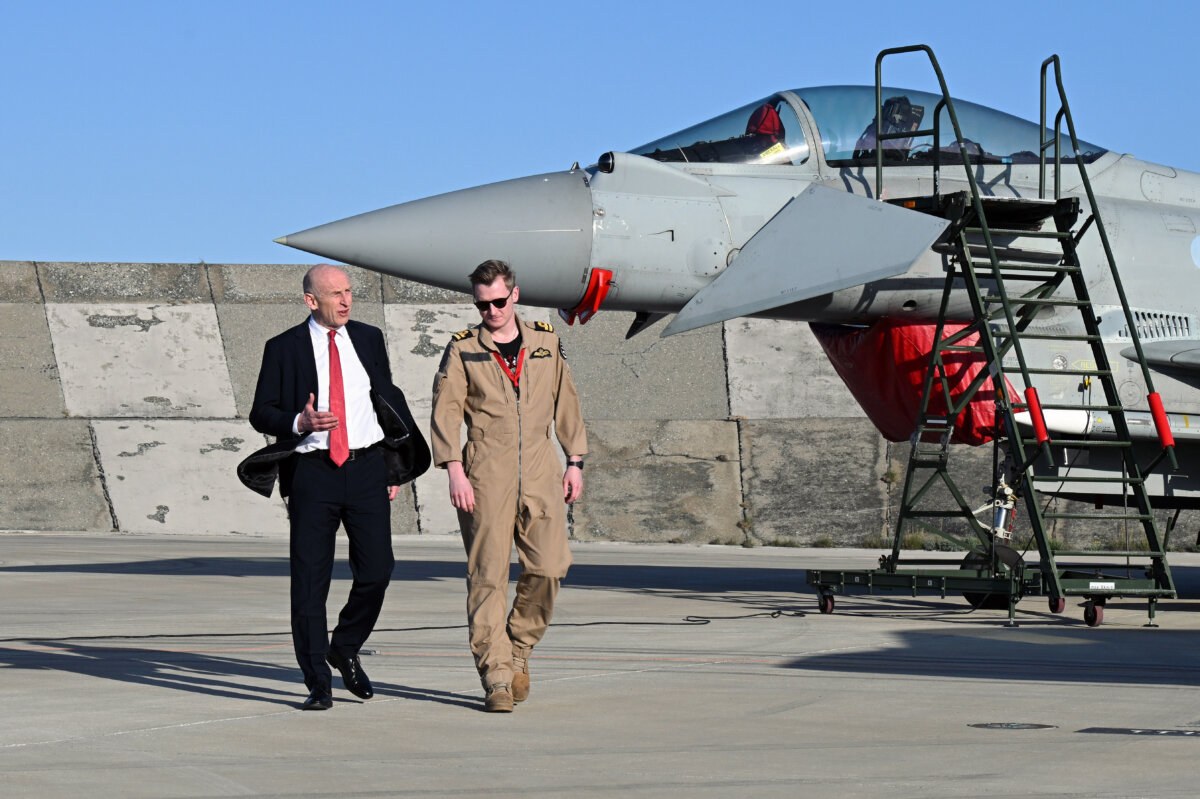 UK Defence Secretary John Healey meets the unidentified British F-35 pilot who shot down a drone as they walk past a fighter jet at RAF Akrotiri in Cyprus on March 5, 2026. (Leon Neal/Getty Images)