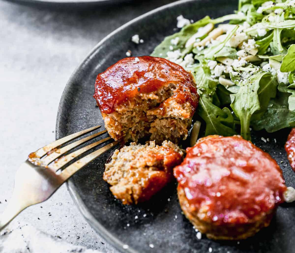 Our easy and delicious Mini Meatloaf recipe is cooked in a muffin tin, taking less time than traditional meatloaf, and is a kid favorite meal we all crave. (Lauren Allen)