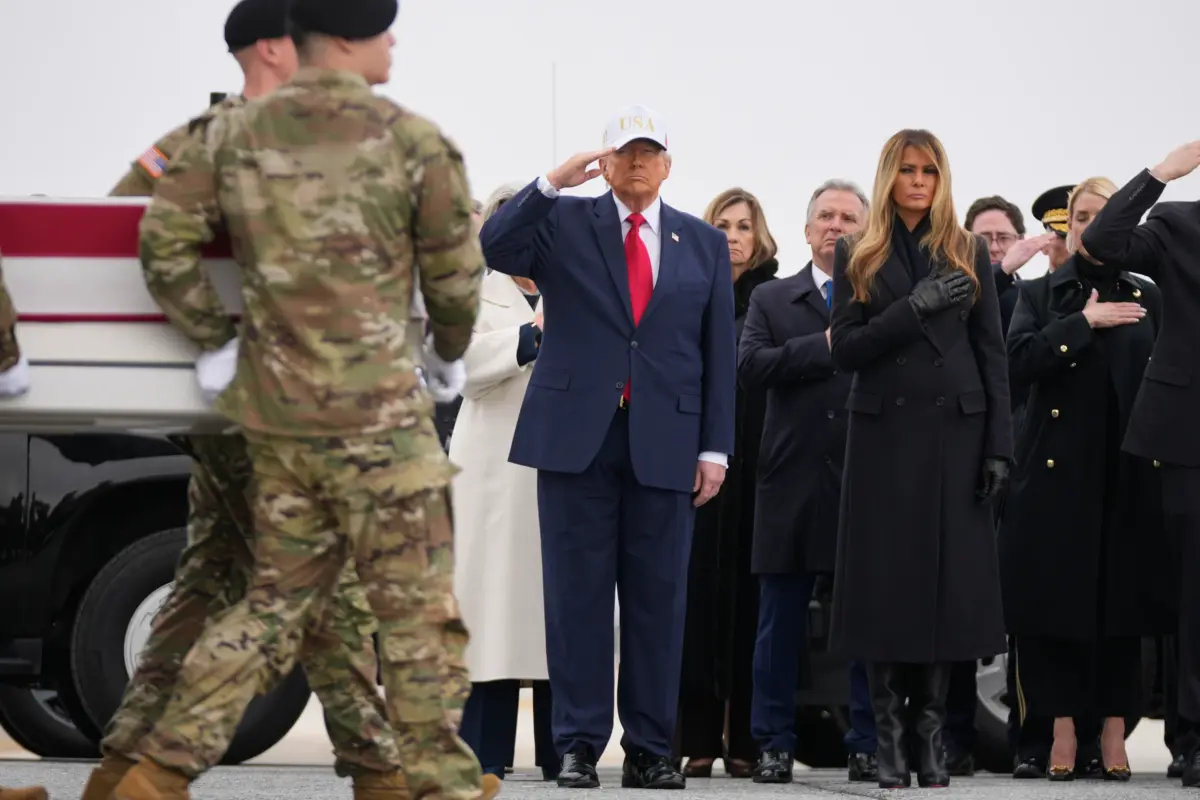 An Army carry team moves a flag-draped transfer case with the remains of U.S. Army Reserve soldier Sgt. 1st Class Nicole Amor, of White Bear Lake, Minn., who was killed in a drone strike at a command center in Kuwait after the U.S. and Israel launched its military campaign against Iran, past President Donald Trump and First Lady Melania Trump during a casualty return, at Dover Air Force Base, Del., on March 7, 2026. (Mark Schiefelbein/AP Photo)