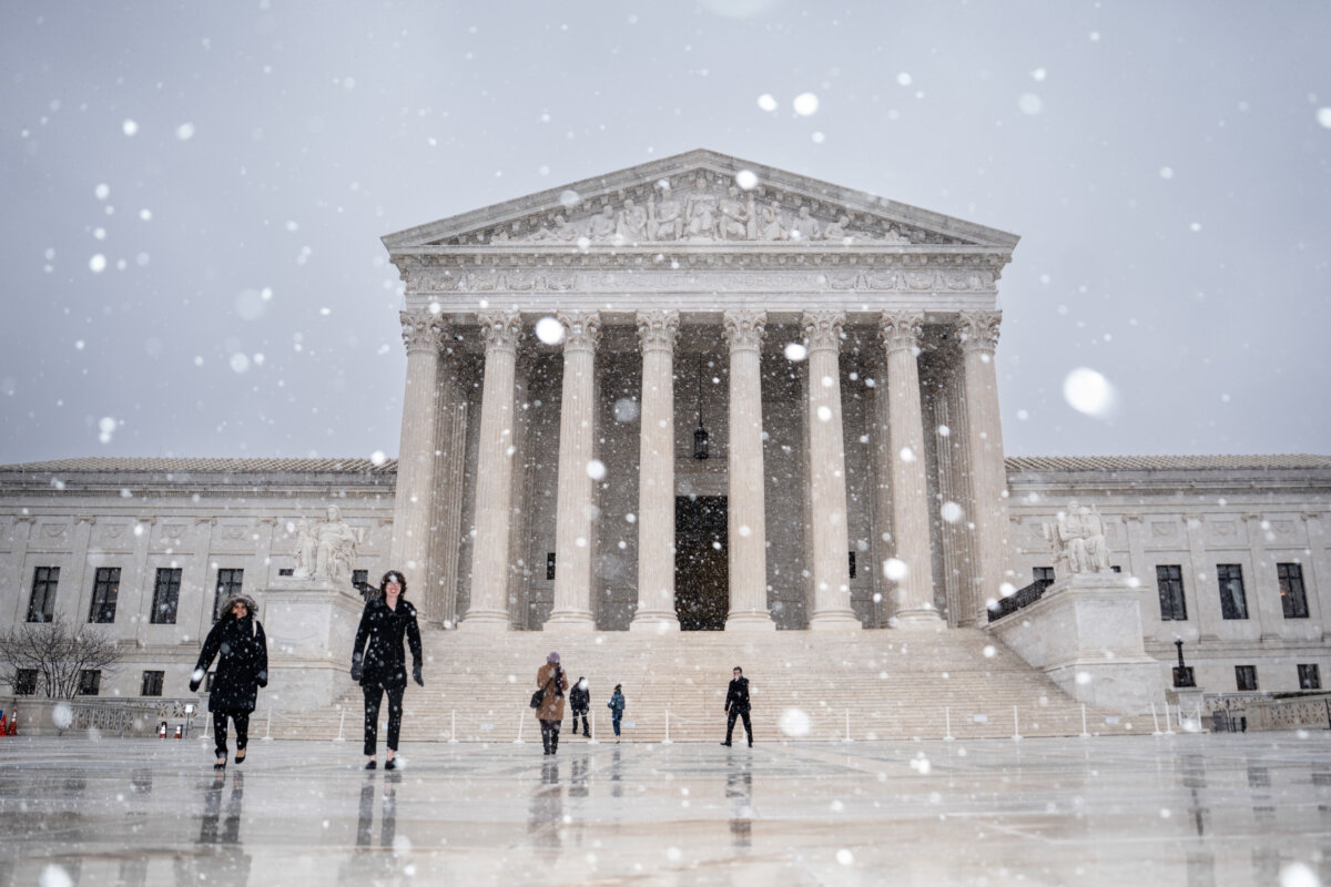 Snow falls outside of the Supreme Court in Washington on March 2, 2026. (Madalina Kilroy/The Epoch Times)