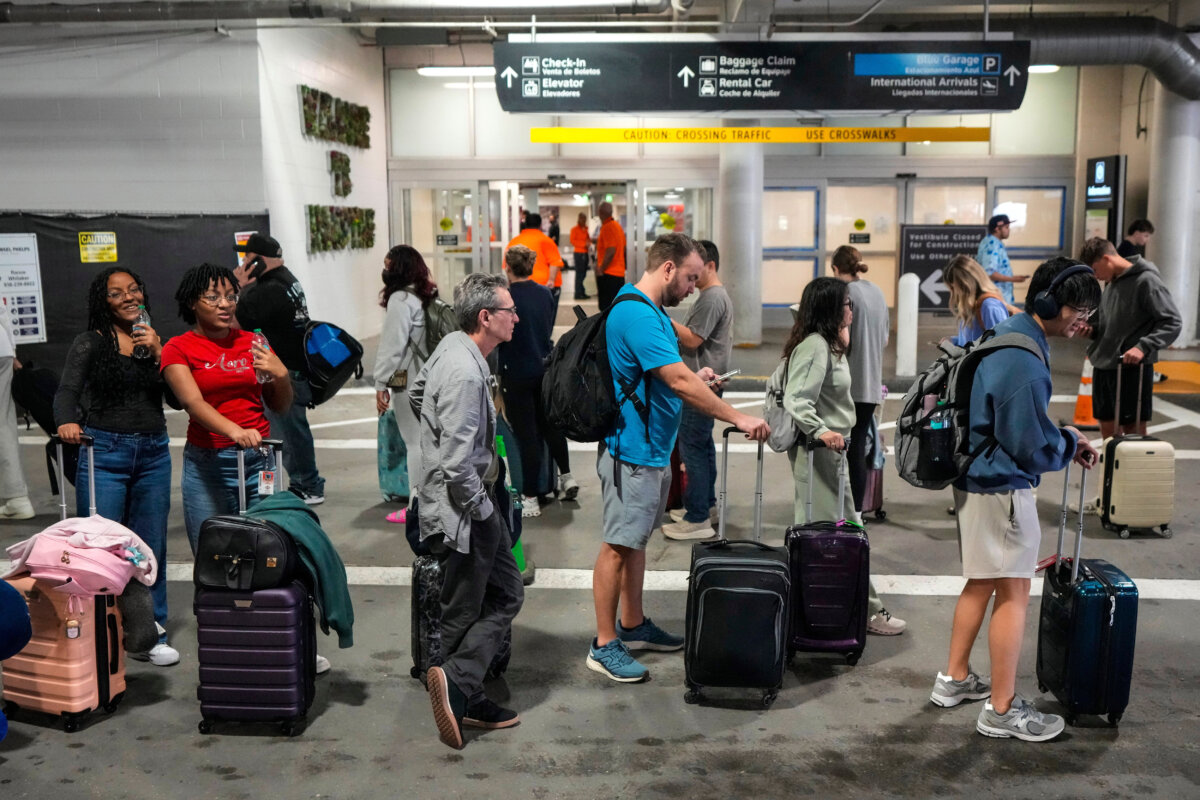 Airline passengers wait in long lines outside the terminal to get through the TSA security screening at William P. Hobby Airport in Houston on March 8, 2026. (Brett Coomer/Houston Chronicle via AP)
