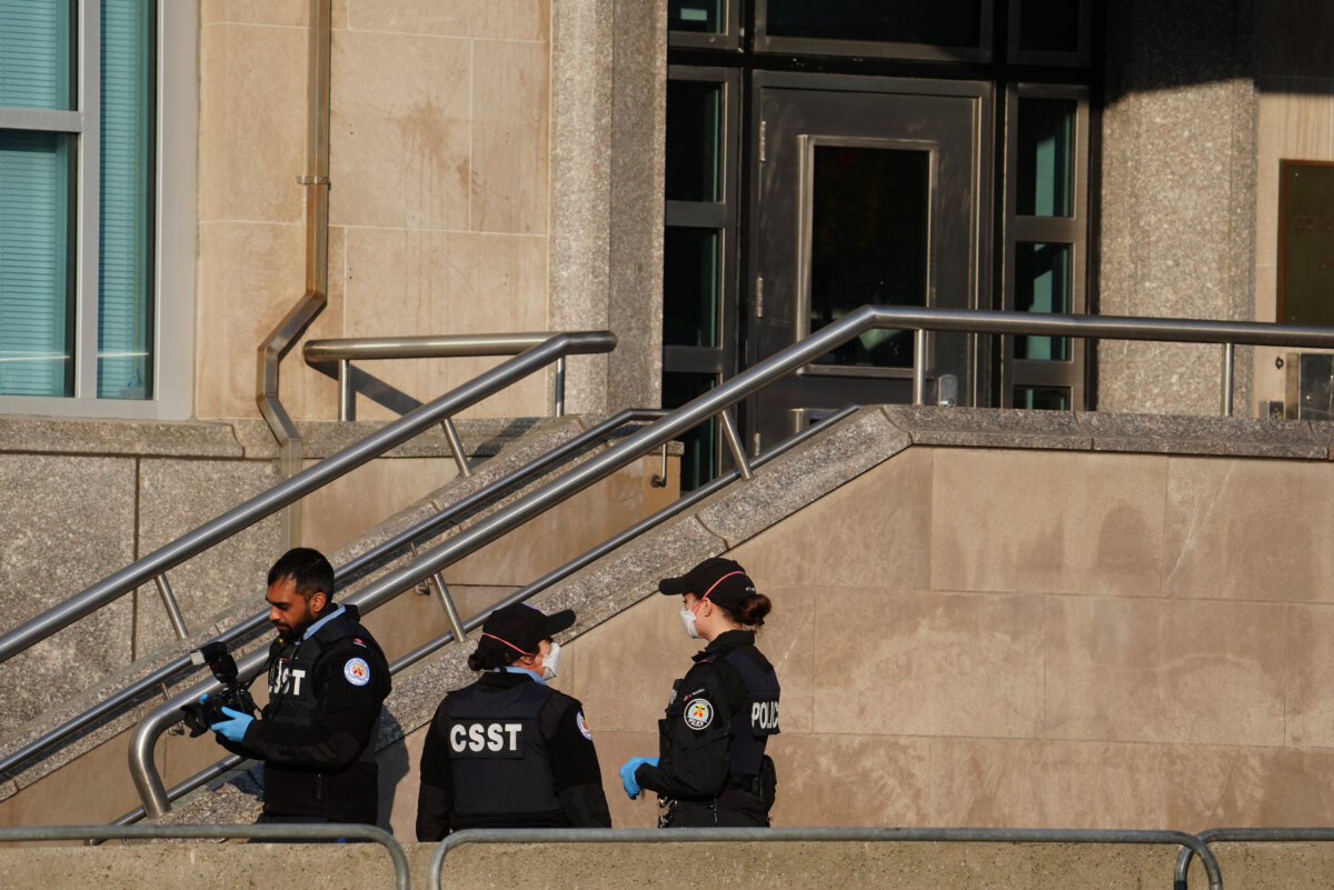 Forensic Toronto police officers looks for evidence at the U.S. consulate in Toronto on March 10, 2026. Police are investigating reports that the United States consulate in Toronto's downtown core was hit by early morning gunfire on March 10. (The Canadian Press/Frank Gunn)