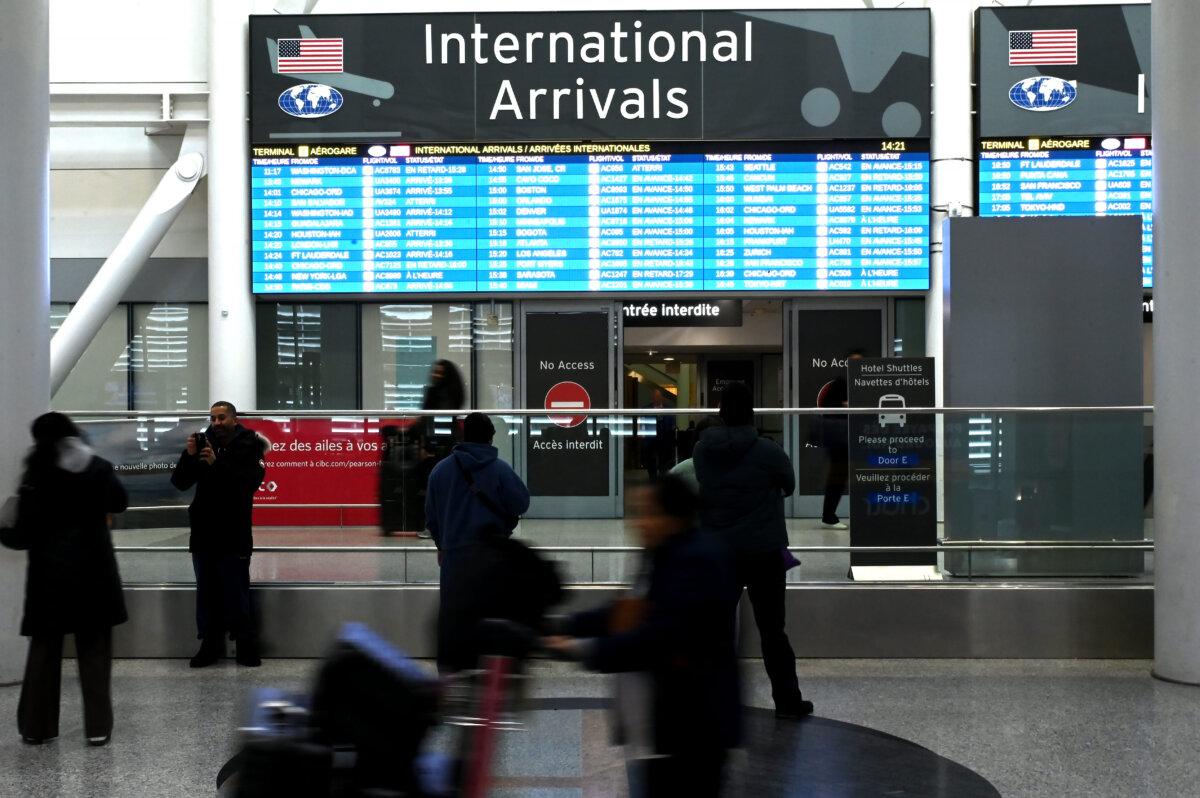 Passengers arrive at Pearson International Airport in Toronto on Feb.11, 2026. (The Canadian Press/Jon Blacker)