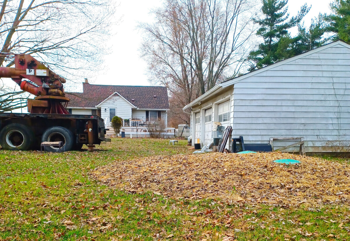 The green discs visible in the straw are service lids to a septic tank that was installed too high. As a result of this preventable error, the sewage line from the house to the tank did not have the required pitch called for in the plumbing code. (Tim Carter/Tribune Content Agency/TNS)