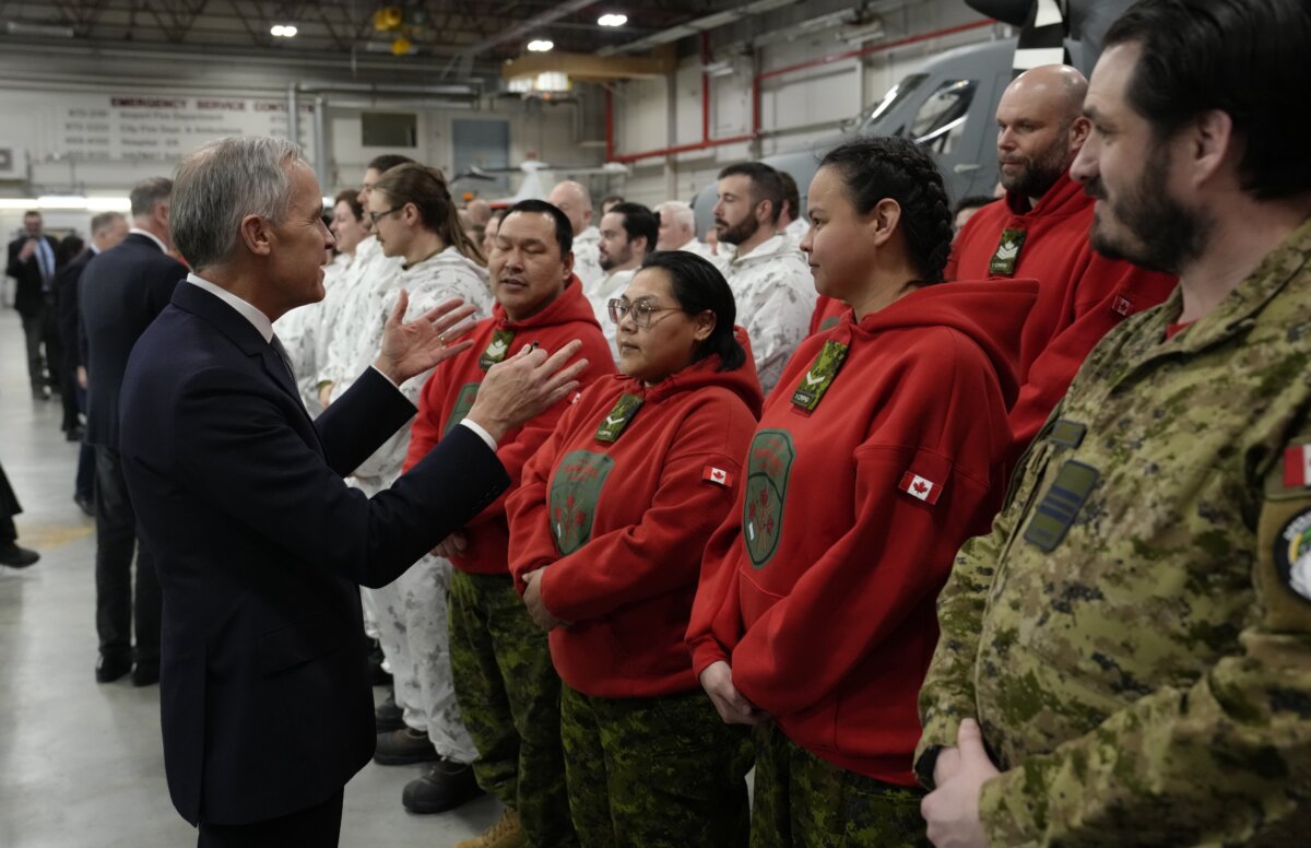 Prime Minister Mark Carney speaks with troops following an announcement to defend and transform Canada's Northern and Arctic regions in Yellowknife, N.W.T., on, March 12, 2026. (The Canadian Press/Adrian Wyld)