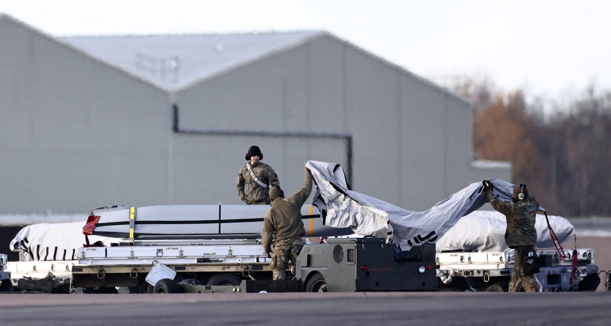 U.S. Air Force military personnel work on AGM-158 joint air-to-surface standoff cruise missiles, near a U.S. Air Force B-1 Lancer bomber jet on the tarmac after it landed at RAF Fairford in south-west England on March 13, 2026. Fairford is one of two bases, along with the Diego Garcia facility in the Indian Ocean, that the UK has given the US permission to use for "specific defensive operations into Iran" to destroy Iranian missiles at source, the British defence minister said in a statement. (Henry Nicholls/AFP via Getty Images)