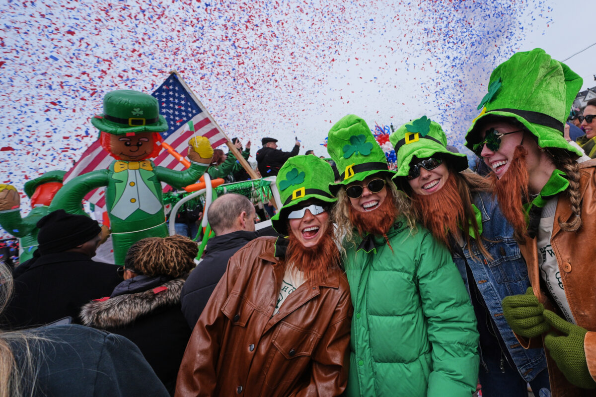 Women wearing leprechaun hats and beards smile as confetti cannons blast during the annual St. Patrick's Day parade through the South Boston neighborhood in Boston on March 15, 2026. (Charles Krupa/AP Photo)