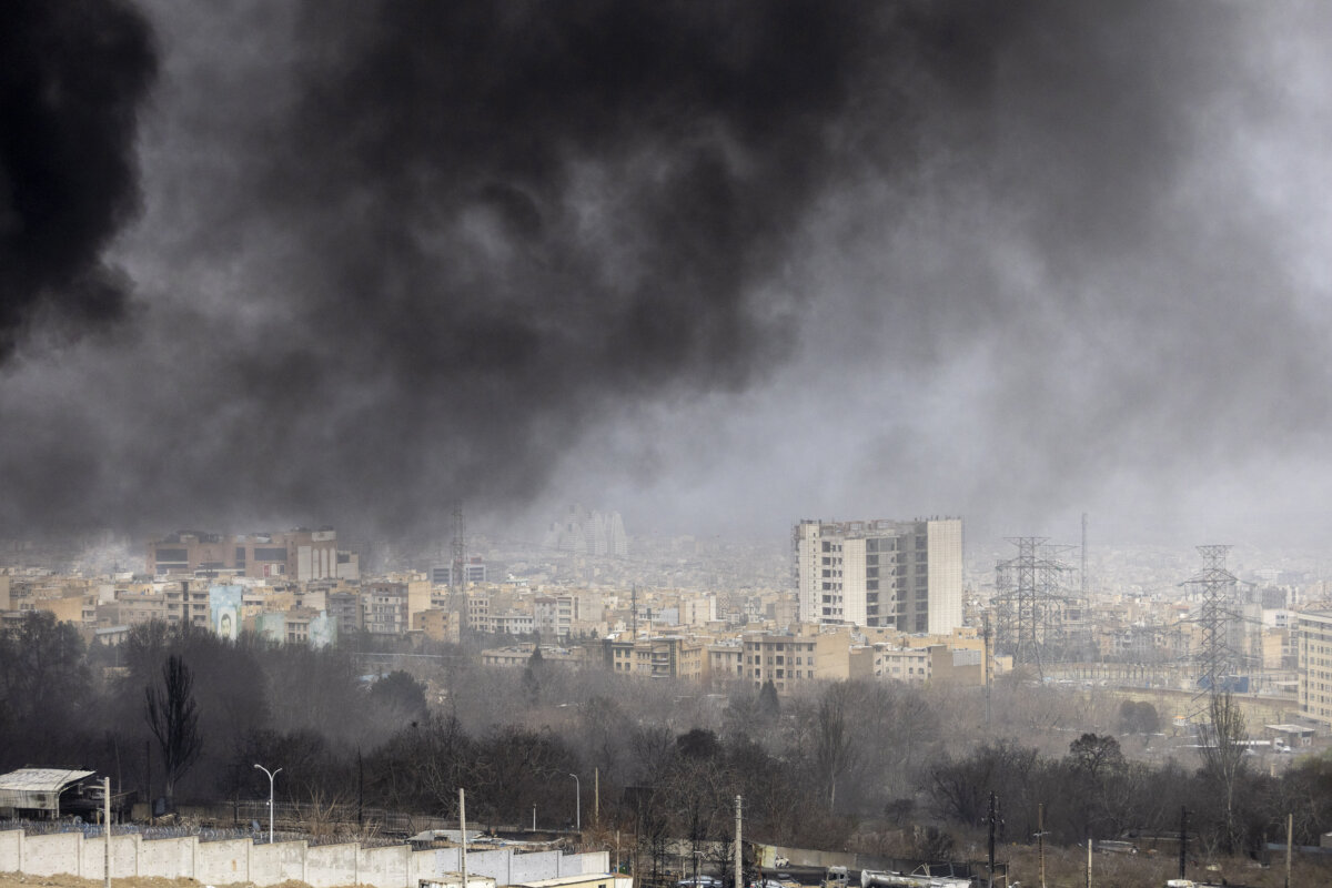 Smoke billows after overnight airstrikes on oil depots in Tehran, Iran, on March 8, 2026. (Majid Saeedi/Getty Images)