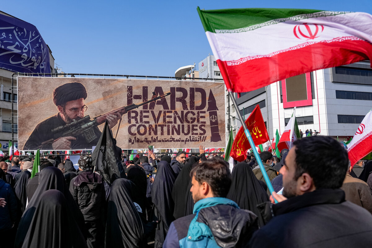 A banner depicting Ayatollah Mojtaba Khamenei, Iran's new supreme leader and the son of slain leader Ayatollah Ali Khamenei, is displayed as he is shown holding a gun at Enghelab Square in Tehran, Iran, on March 11, 2026, as attendees gather for funerals of commanders from the Islamic Revolutionary Guard Corps, the army, and others killed in the early days of U.S. and Israeli strikes on Iran. (Khoshiran/Middle East Images/AFP/Getty Images)