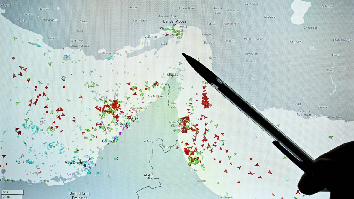 A person points at a page on the Marinetraffic website that shows commercial boats traffic on the edge of the Strait of Hormuz near the Iranian coast on March 4, 2026. (Julien de Rosa/AFP via Getty Images)