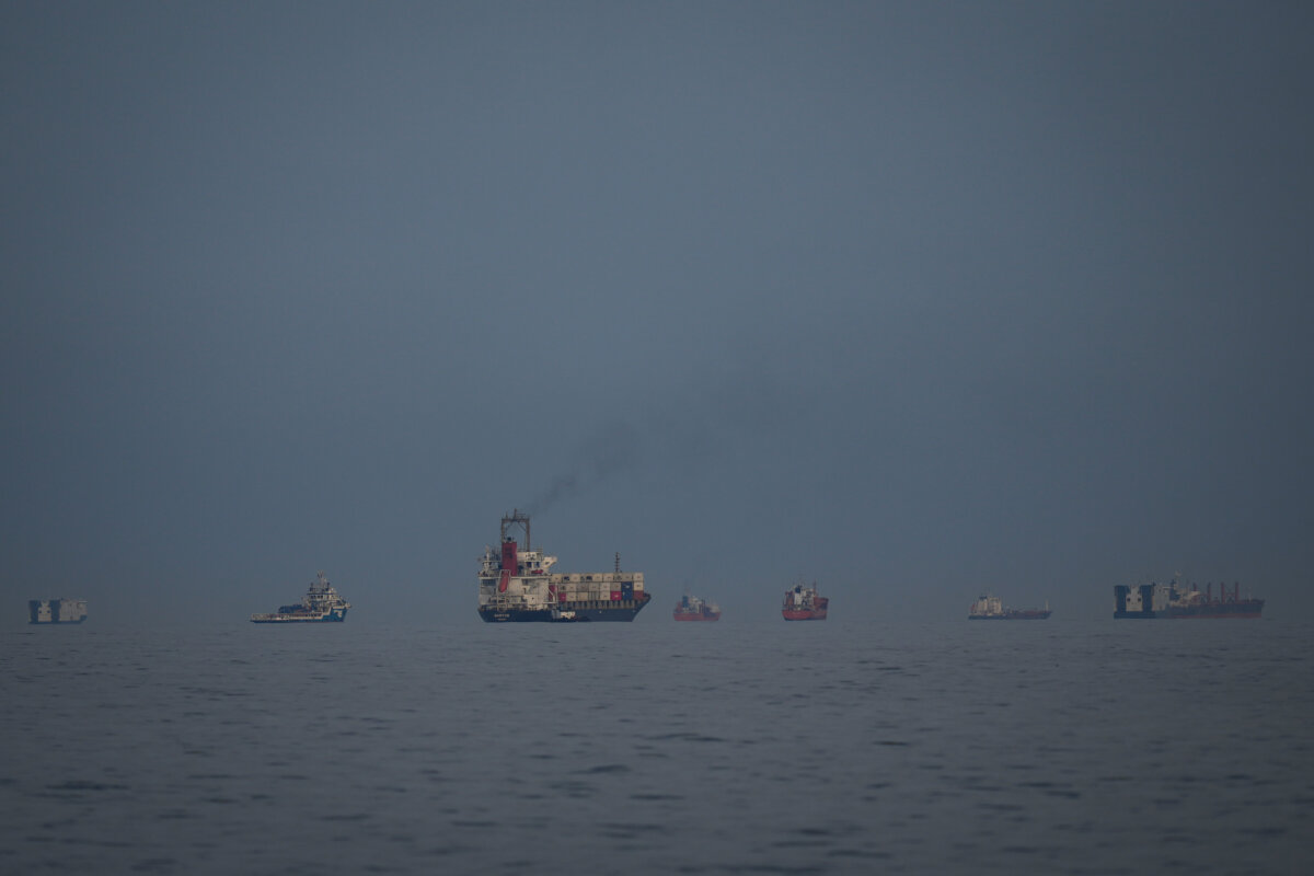 Oil tankers and cargo ships line up in the Strait of Hormuz as seen from Khor Fakkan, United Arab Emirates, on March 11, 2026. (Altaf Qadri/AP Photo)