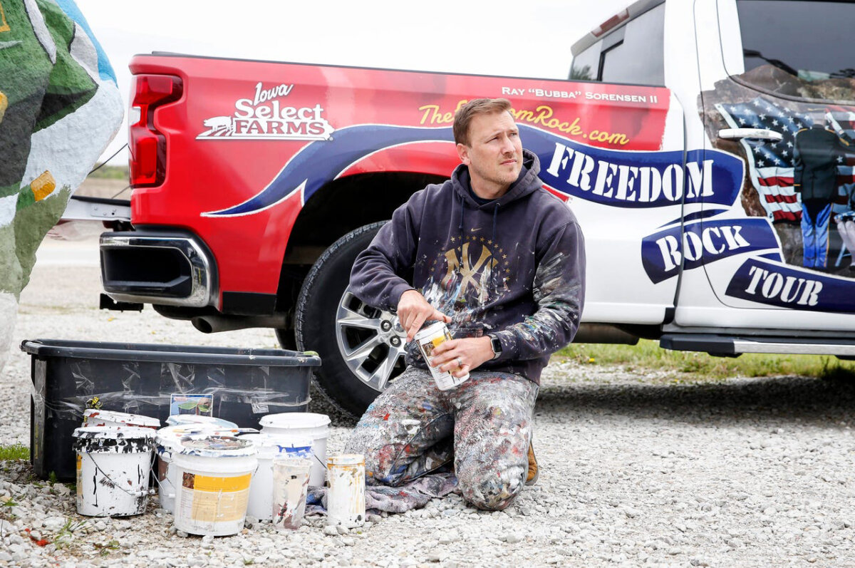 Ray “Bubba” Sorensen II sits next to the paint he uses to paint rocks. (Sorensen Studios)