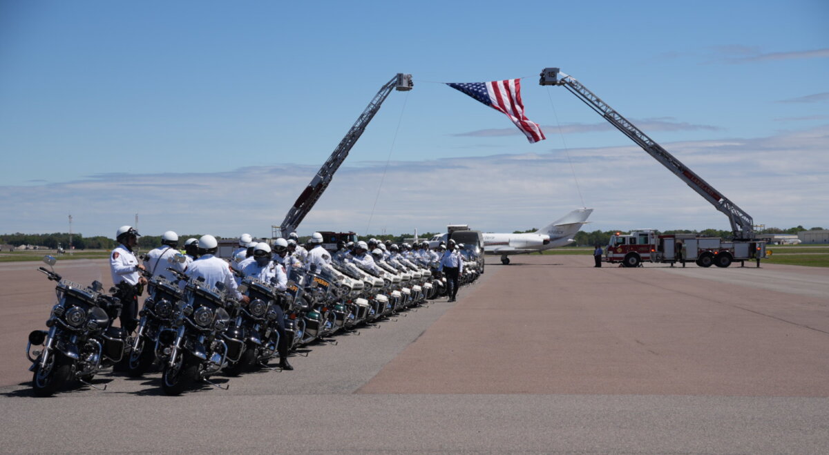 Law enforcement officers await the arrival of the remains of Major Cody Khork who was killed in the Iran War. A funeral procession was held in Khork's hometown of Winter Haven, Fla., on March 18, 2026. (Troy Myers/The Epoch Times)