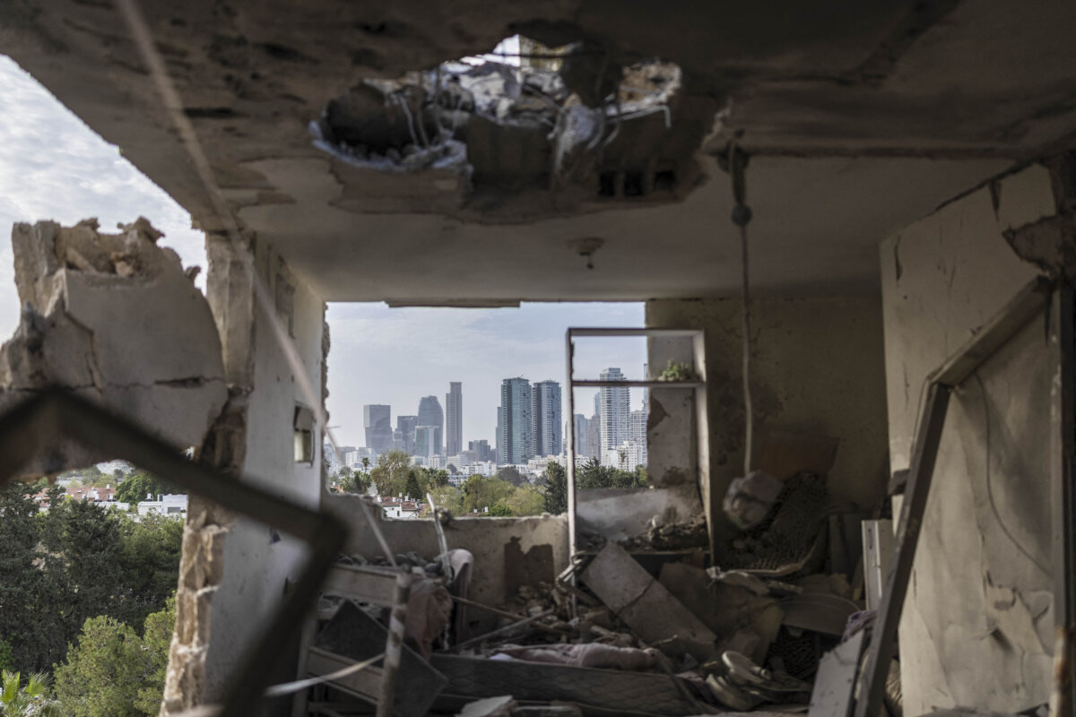 The interior of a destroyed apartment with the Tel Aviv skyline visible in the background following an overnight Iranian missile strike in Tel Aviv, Israel, on March 19, 2026. (Ilia Yefimovich /AFP via Getty Images)