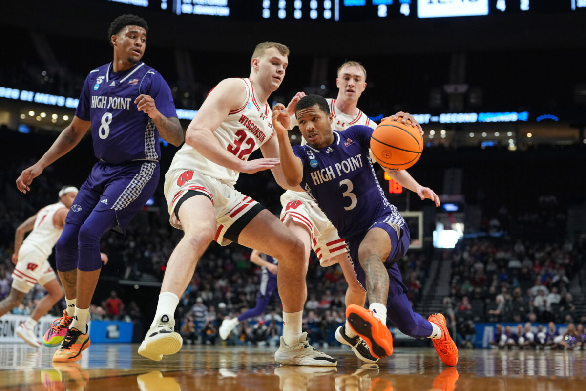 Rob Martin #3 of the High Point Panthers drives against Aleksas Bieliauskas #32 of the Wisconsin Badgers during the second half in the first round of the 2026 NCAA Men's Basketball Tournament at Moda Center in Portland, Ore., on March 19, 2026. (Soobum Im/Getty Images)