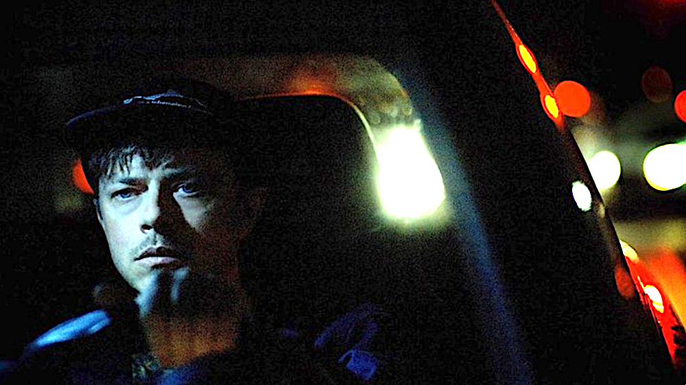 man driving at night in car in Wardriver