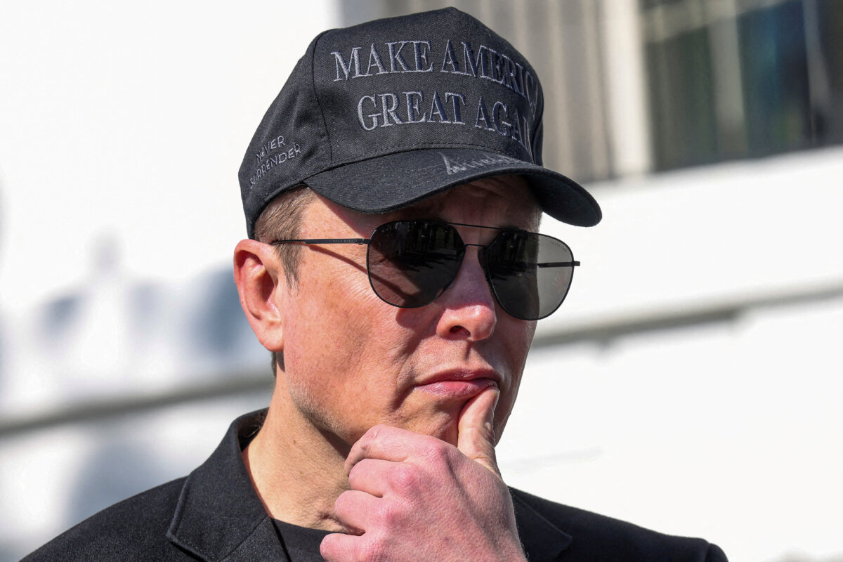 Tesla CEO Elon Musk looks on next to President Donald Trump talking to the media, at the White House on March 11, 2025. (Kevin Lamarque//Reuters)