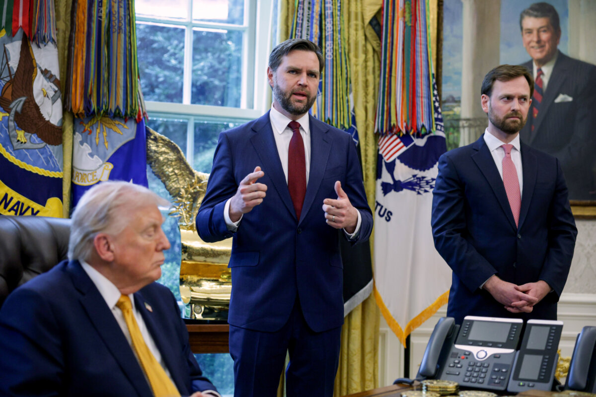 President Donald Trump (L) and Federal Trade Commission Chairman Andrew Ferguson (R) listen as Vice President JD Vance (C) speaks to reporters after Trump signed paperwork during a White House signing ceremony on March 16, 2026. (Alex Wong/Getty Images)