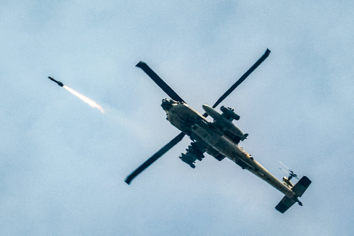 An Israeli Air Force AH-64 Apache attack helicopter fires rockets along the Israel–Lebanon border on March 18, 2026. (Jalaa Marey/AFP via Getty Images)