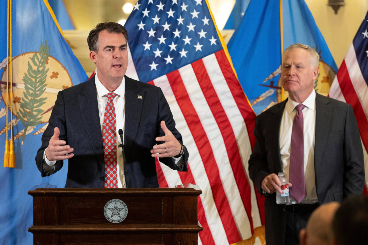 Oklahoma Gov. Kevin Stitt (L) and his appointee to the U.S. Senate, Alan Armstrong, speak to state leaders, reporters, and friends after Armstrong was announced as Stitt’s choice to temporarily fill Senator Markwayne Mullin’s seat during a press conference at the Oklahoma State Capitol in Oklahoma City on March 24, 2026. (Alonzo Adams/AP Photo)