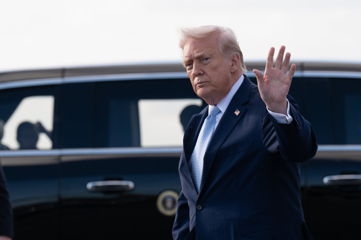 President Donald Trump waves after landing at Palm Beach International Airport on March 20, 2026. (Roberto Schmidt/Getty Images)