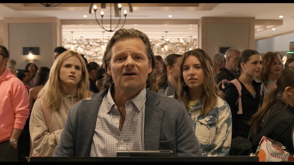 man and two girls at hotel front desk in She Dances