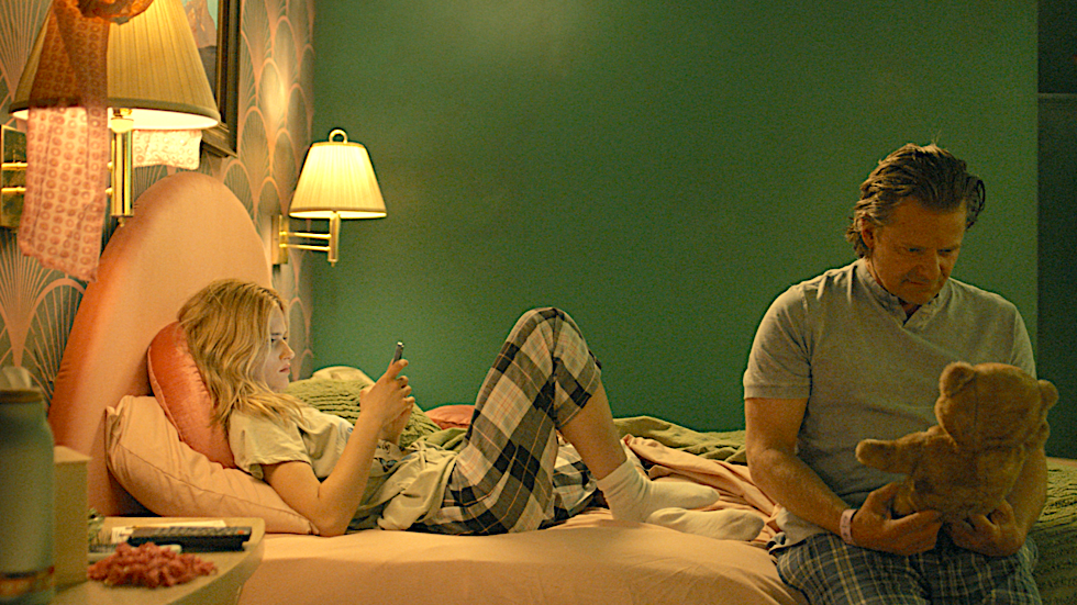 man and girl sit on a bed in She Dances