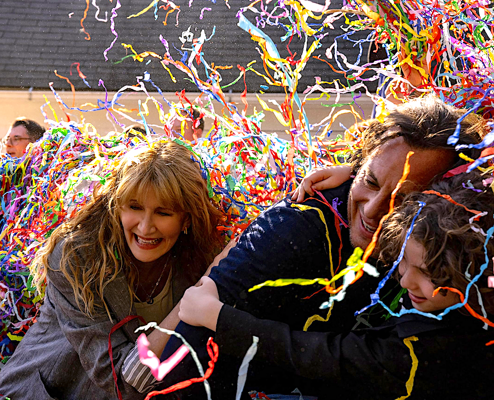 man, woman, and child having fun with confetti in Is This Thing On?