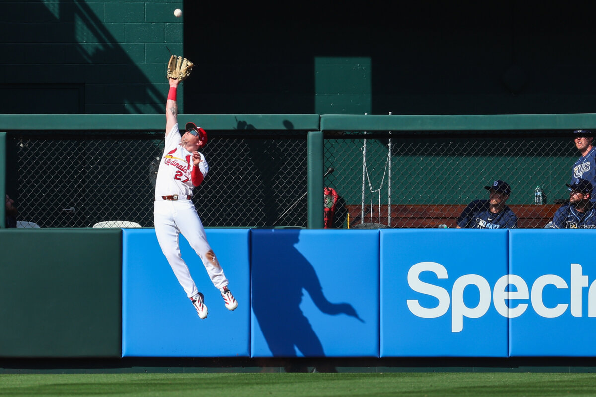 A modern outfielder secures a fly ball with a padded leather glove, a piece of equipment that has evolved dramatically since baseball's early days. (Dilip Vishwanat/Getty Images)