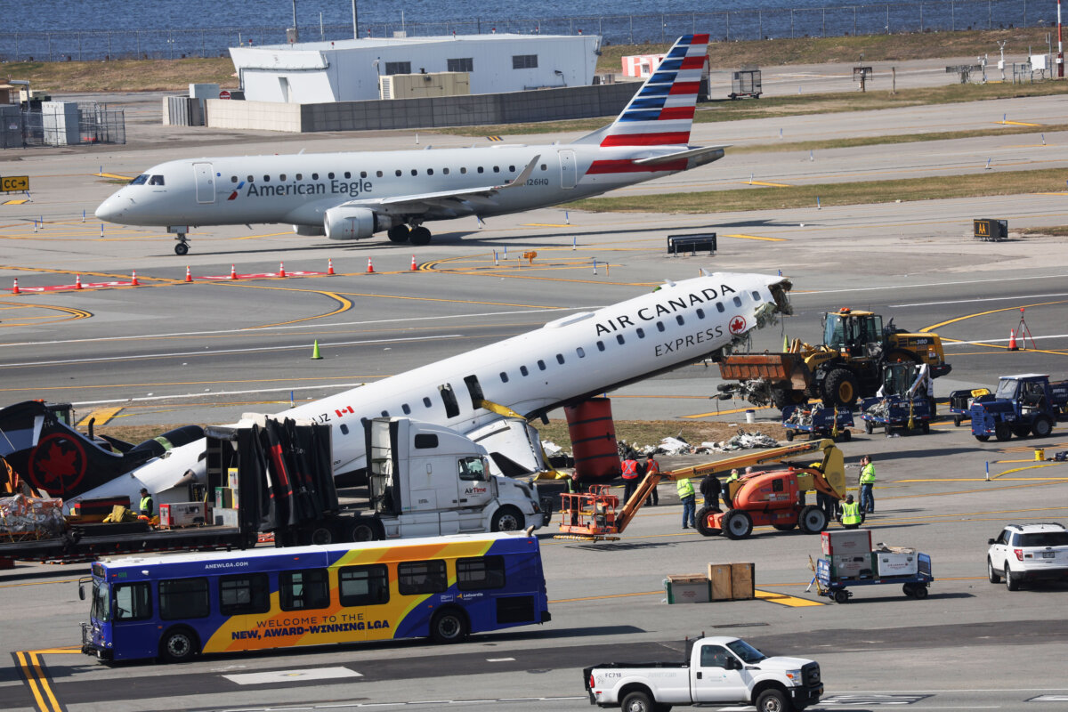 An Air Canada Express plane that collided with a fire truck on the tarmac sits along the runway during an ongoing investigation at LaGuardia Airport in New York City on March 25, 2026. The plane had landed after a flight from Montreal when it collided with a fire truck, resulting in the deaths of the two pilots and dozens of injuries. (Spencer Platt/Getty Images)