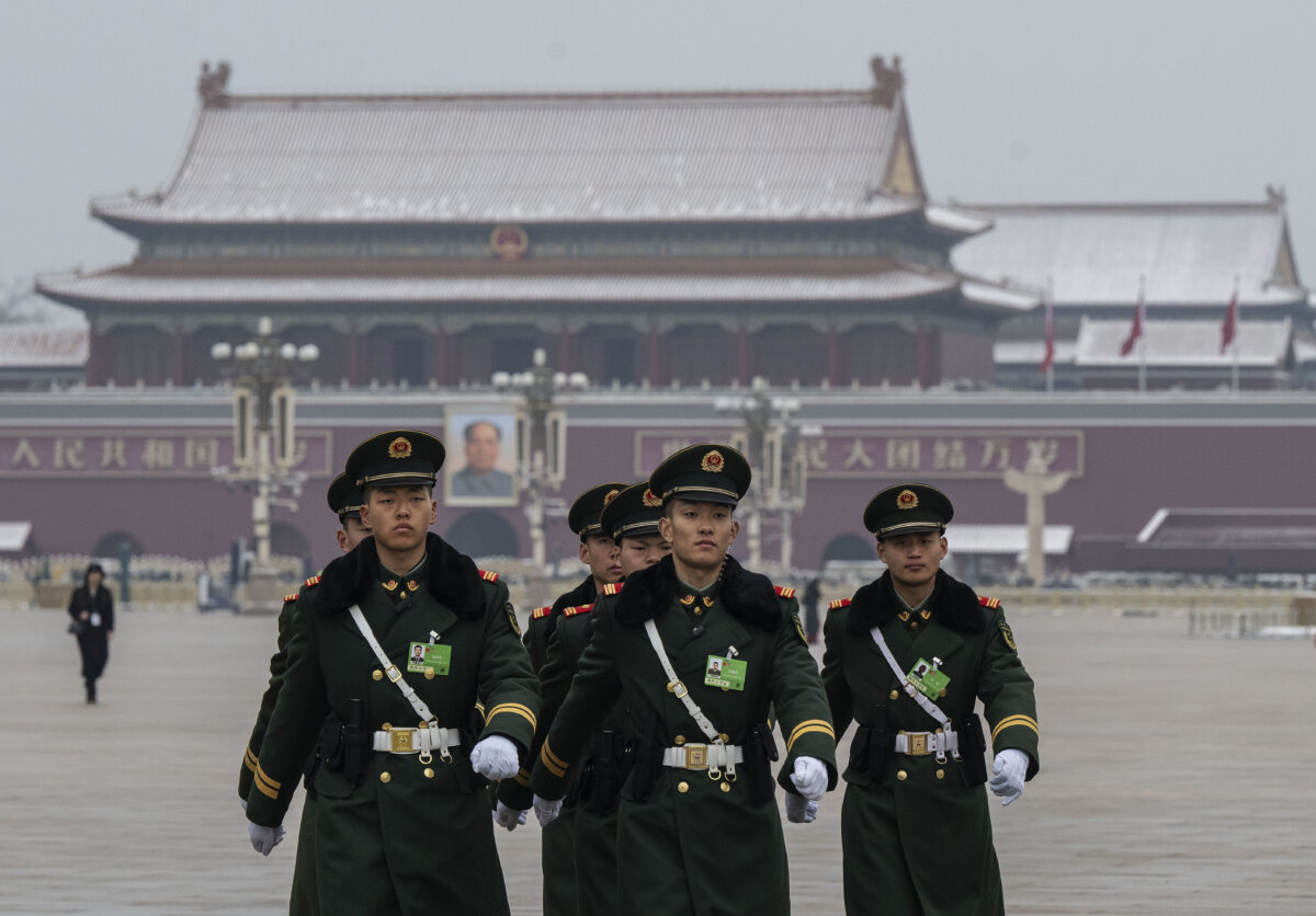 Members of the People's Armed Police march in front of a portrait of former Chinese leader Mao Zedong at Tiananmen Square in Beijing on March 5, 2026. (Kevin Frayer/Getty Images)