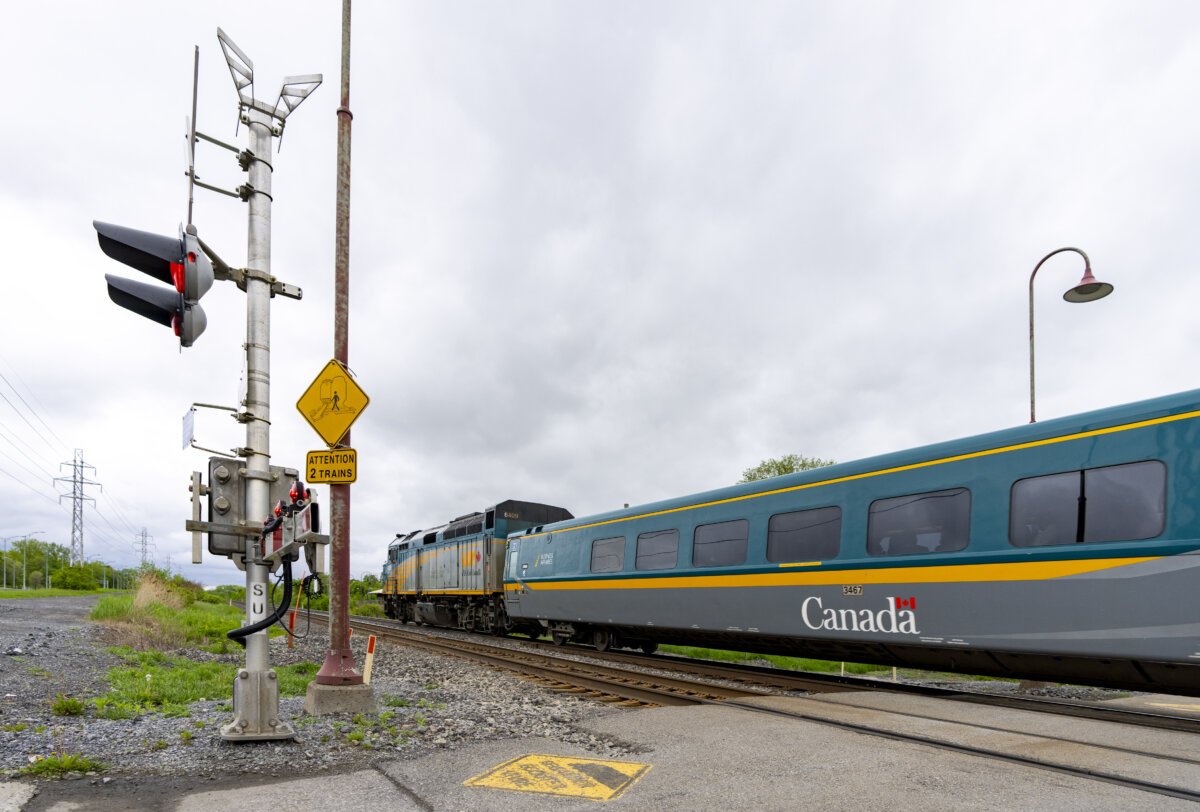 A Via Rail train is seen on tracks in the Montreal suburb of Beaconsfield as it heads out of the city on May 23, 2025. (The Canadian Press/Christinne Muschi)