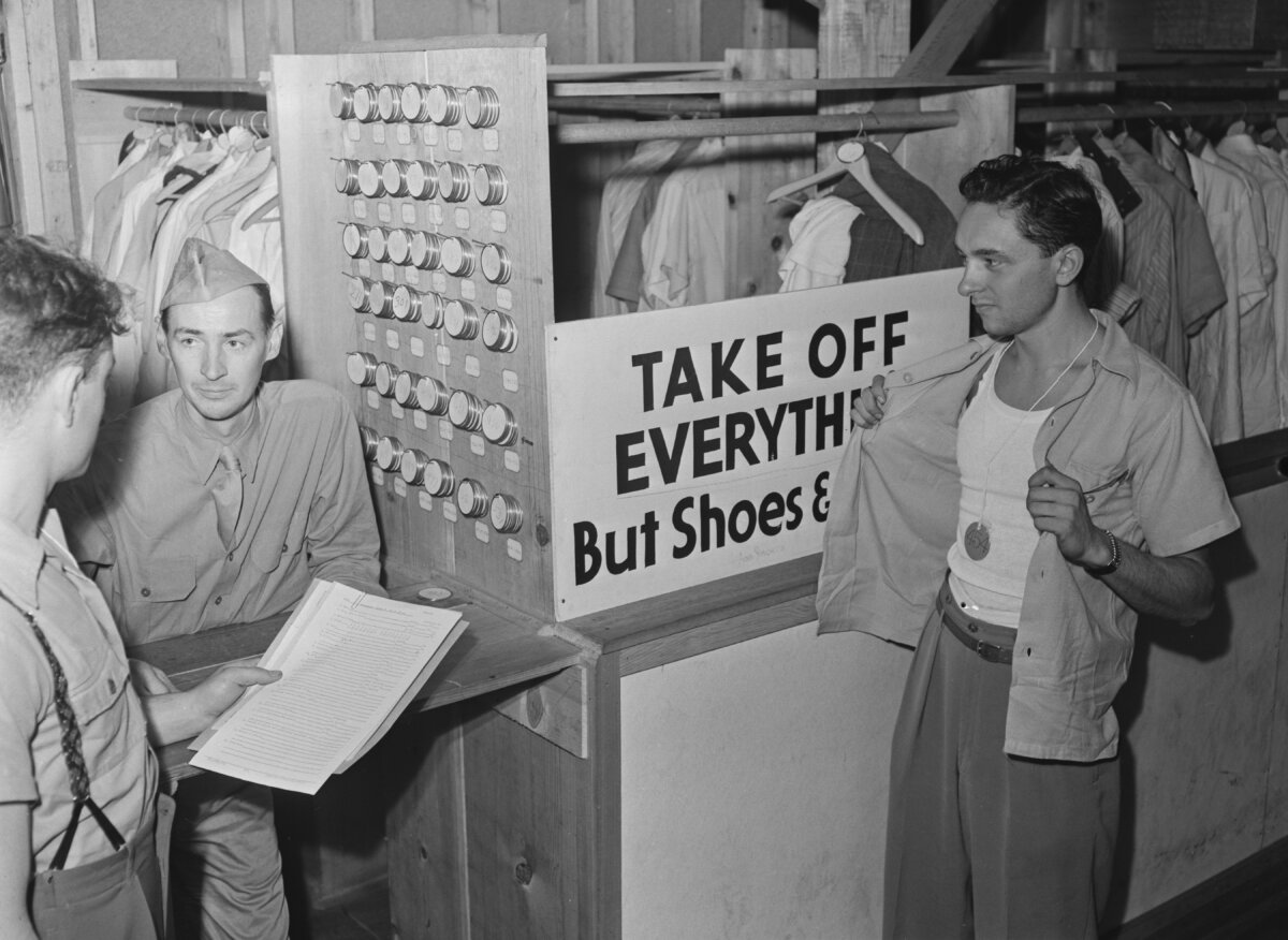 Newly-drafted U.S. soldiers are instructed to take off everything but their shoes and shorts for a physical examination at the Army Induction Center on Governors Island, New York City, during World War II, on Sept. 18, 1941. (Archive Photos/Getty Images)