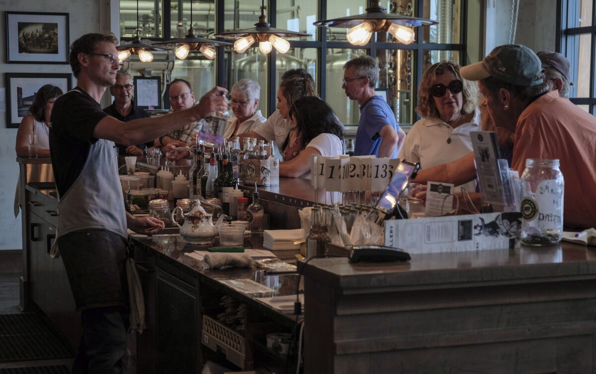 A tour group tastes the offerings at a distillery in Turner Valley, Alta., in a file photo. (The Canadian Press/Jeff McIntosh)