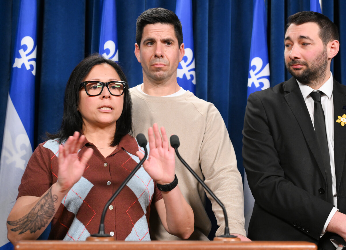 Veronica Martinez, mother of Zachary Miron who died after drinking an energy drink while skiing, speaks at a news conference at the legislature in Quebec City, April 1, 2026. Father David Miron and Québec Solidaire MNA Guillaume Cliche-Rivard, look on. (The Canadian Press/Jacques Boissinot)