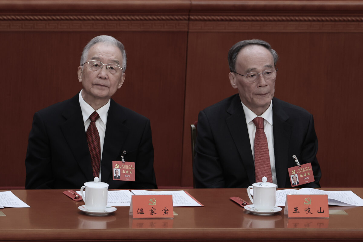 Former Chinese Premier Wen Jiabao (L) and Vice President Wang Qishan attend the closing ceremony of the 20th National Congress of the Communist Party of China (CPC) at the Great Hall of the People on October 22, 2022 in Beijing. (Lintao Zhang/Getty Images)