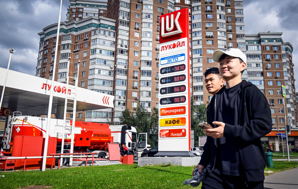 People walk past a gas station in Moscow on Sept. 8, 2025. (Alexander Nemenov/AFP via Getty Images)