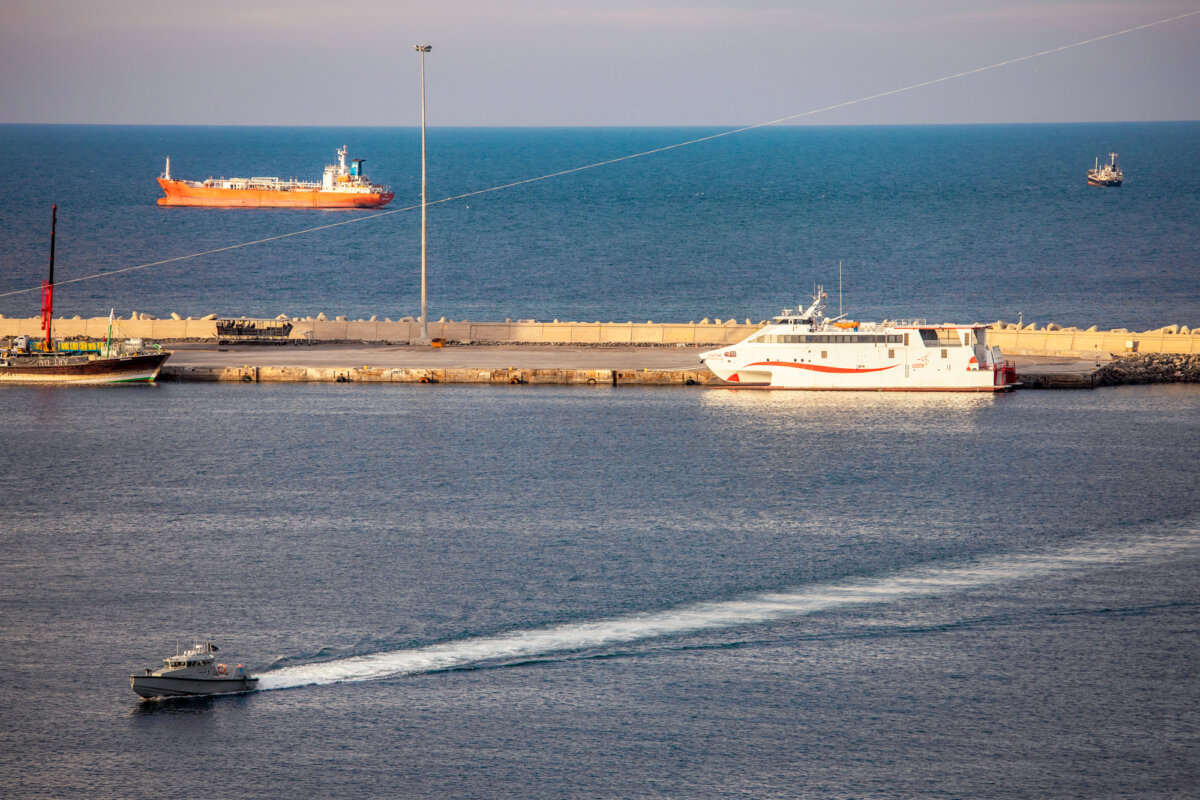 A police speedboat patrols the port as oil tankers and high-speed craft sit anchored near the Strait of Hormuz in Muscat, Oman, on March 30, 2026. (Elke Scholiers/Getty Images)