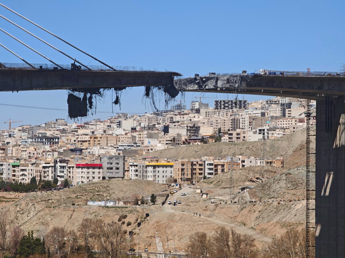 Concrete and rebar dangle from a damaged B1 bridge, a day after it was destroyed by an airstrike, west of Tehran in Karaj, Iran, on April 3, 2026. (Majid Saeedi/Getty Images)