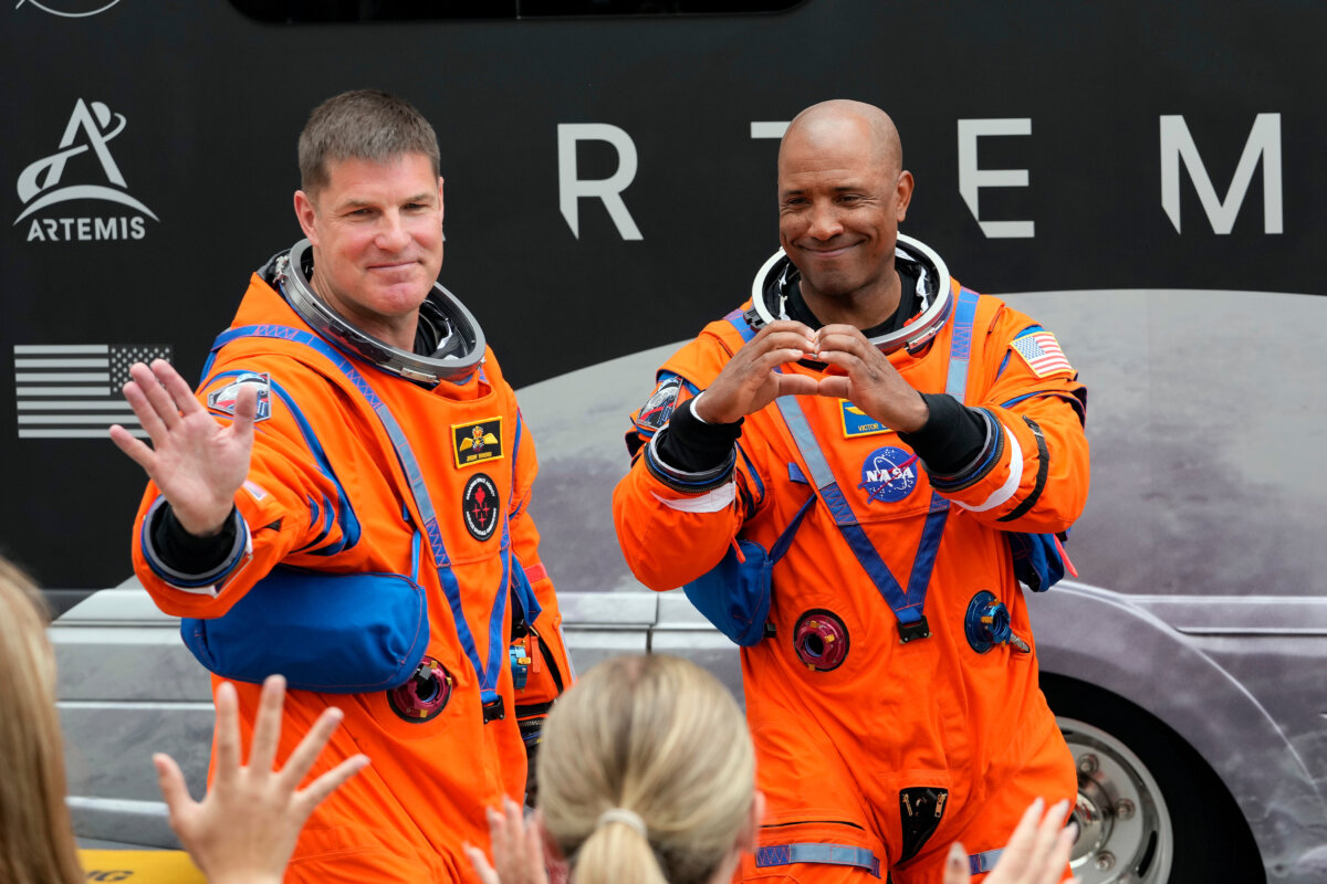 Mission Specialist Jeremy Hansen of Canada and pilot Victor Glover wave to family members as they leave the Operations and Checkout Building for a trip to Launch Pad 39-B and a planned liftoff on NASA's Artemis II moon rocket at the Kennedy Space Center on April 1, 2026, in Cape Canaveral, Fla. (AP Photo/Chris O'Meara)