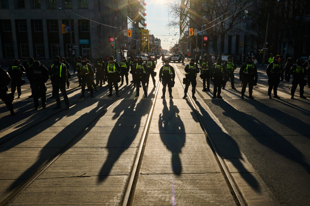 Police line an intersection as protesters march during an "Al Quds Day" rally in Toronto, on March 14, 2026. (The Canadian Press/Sammy Kogan)