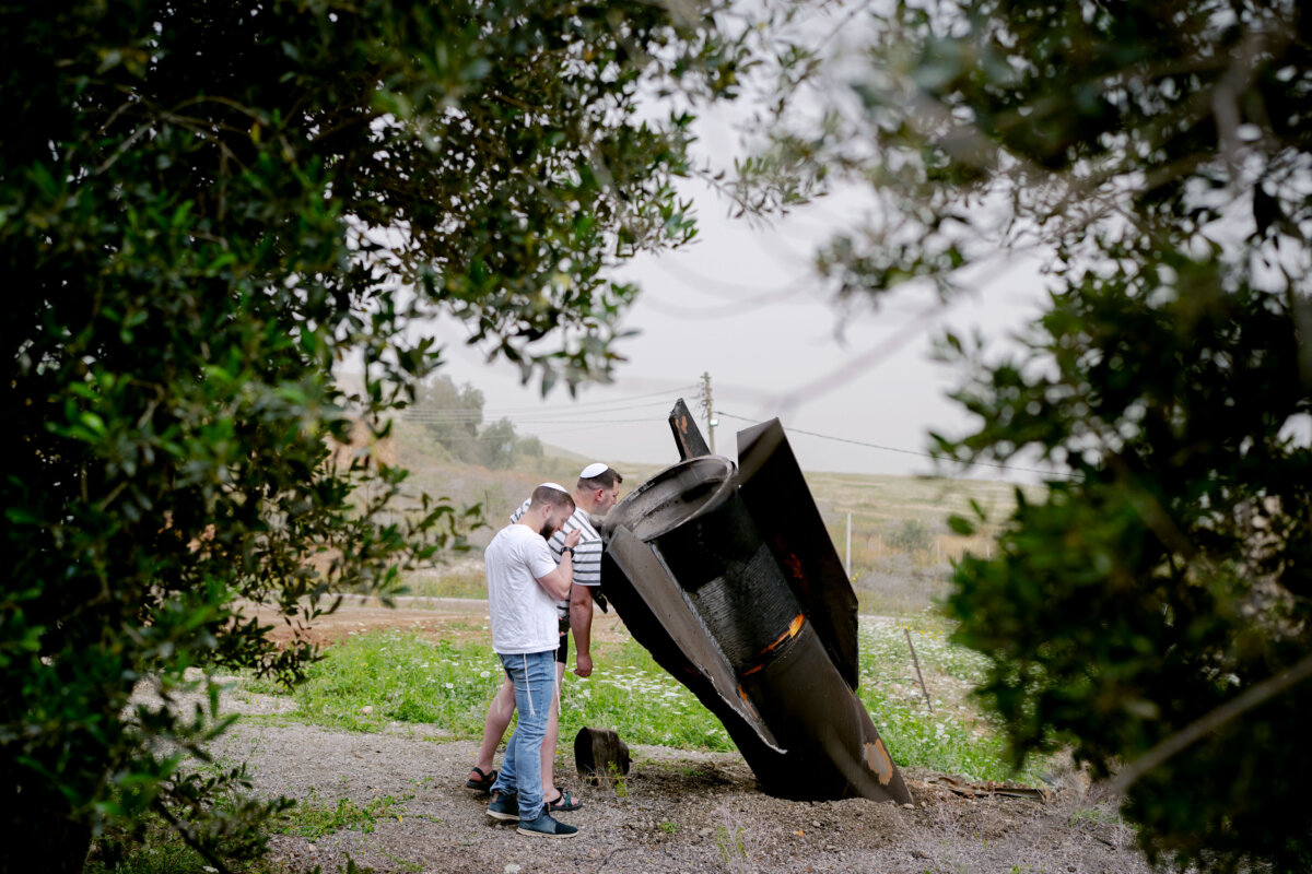 An Israeli man looks at the tail section of a ballistic missile launched from Iran, in the northern Jordan Valley in Shadmot Mehola, Israel, on April 3, 2026. Iran has continued firing waves of drones and missiles at Israel after the United States and Israel launched a joint attack on Iran early on Feb. 28. (Erik Marmor/Getty Images)